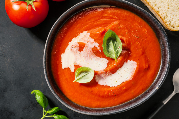 Veg Tomato soup being served in plate